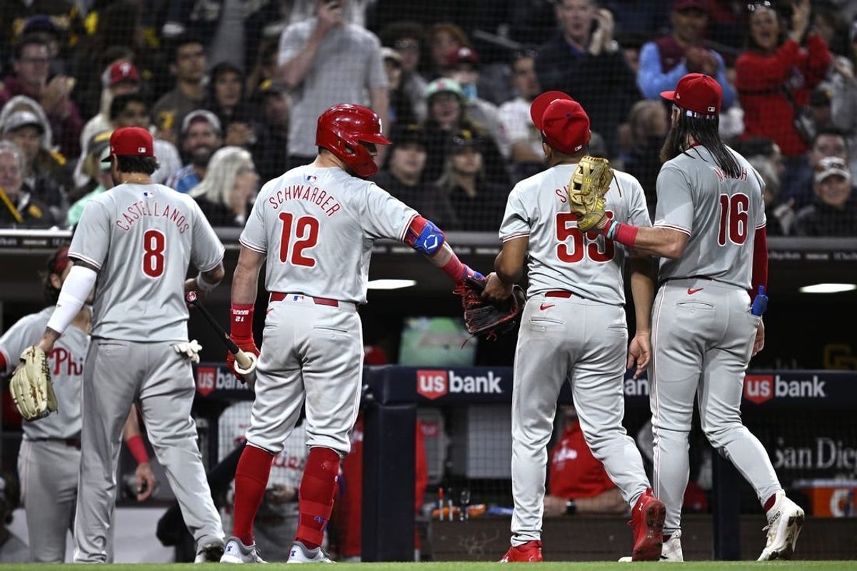 Apr 27, 2024; San Diego, California, USA; Philadelphia Phillies starting pitcher Ranger Suarez (55) is greeted by designated hitter Kyle Schwarber (12) and center fielder Brandon Marsh (16) after pitching the eighth inning against the San Diego Padres at Petco Park.
