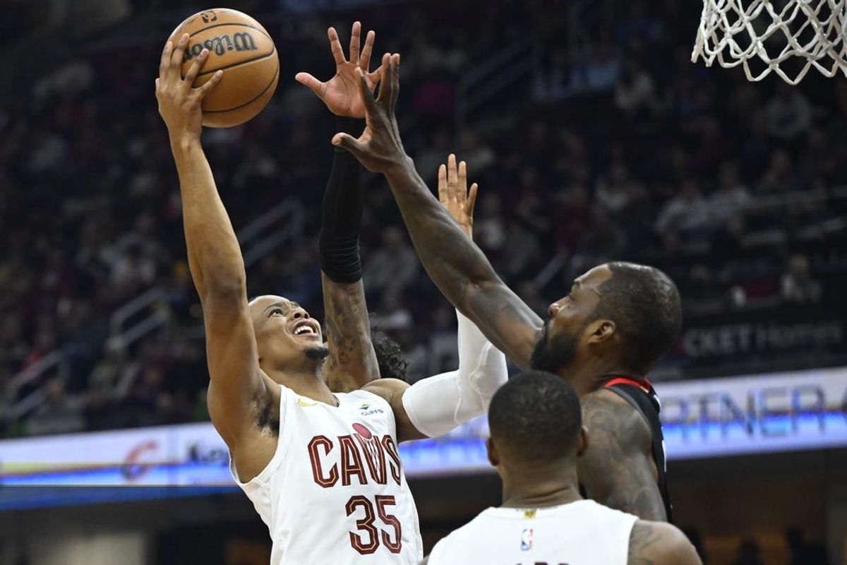 Dec 18, 2023; Cleveland, Ohio, USA; Cleveland Cavaliers forward Isaac Okoro (35) drives to the basket beside Houston Rockets forward Jeff Green (32) in the second quarter at Rocket Mortgage FieldHouse.