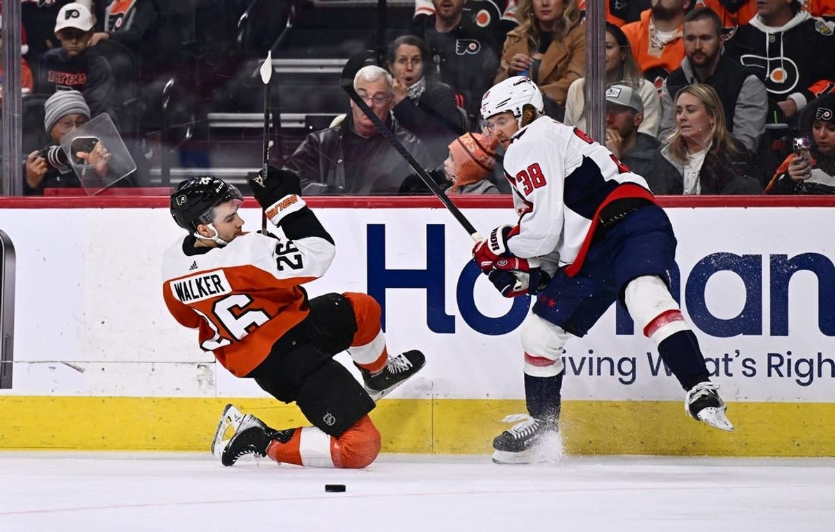 Dec 14, 2023; Philadelphia, Pennsylvania, USA; Philadelphia Flyers defenseman Sean Walker (26) collides with Washington Capitals defenseman Rasmus Sandin (38) in the first period at Wells Fargo Center.