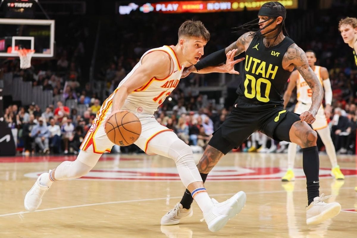 Feb 27, 2024; Atlanta, Georgia, USA; Atlanta Hawks guard Bogdan Bogdanovic (13) drives on Utah Jazz guard Jordan Clarkson (00) in the second quarter at State Farm Arena.