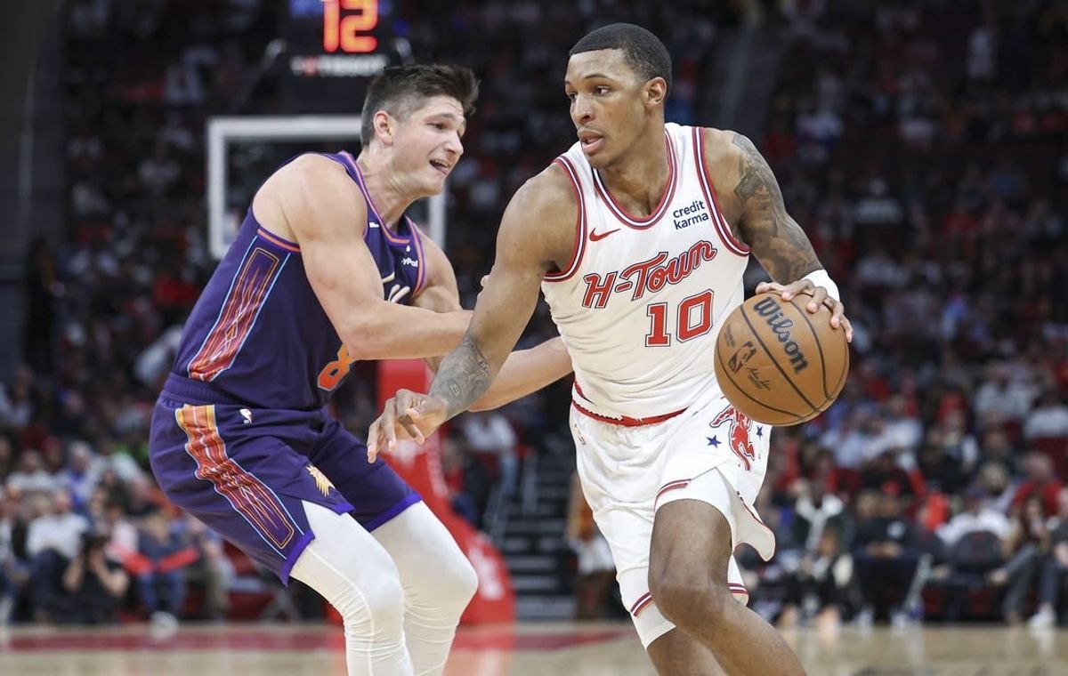 Feb 23, 2024; Houston, Texas, USA; Houston Rockets forward Jabari Smith Jr. (10) dribbles the ball as Phoenix Suns guard Grayson Allen (8) defends during the second quarter at Toyota Center.