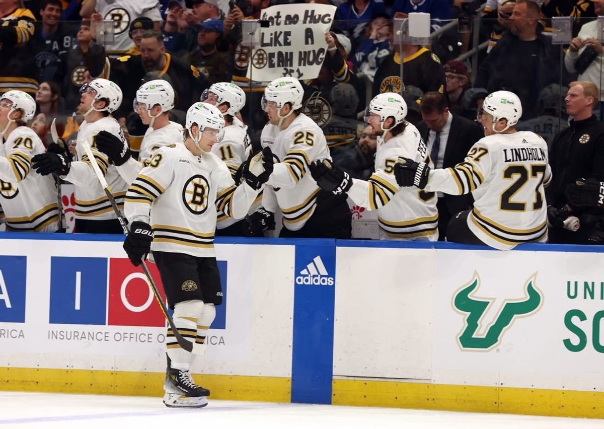 Mar 27, 2024; Tampa, Florida, USA; Boston Bruins left wing Danton Heinen (43) is congratulated after he scored a goal against the Tampa Bay Lightning during the first period at Amalie Arena.