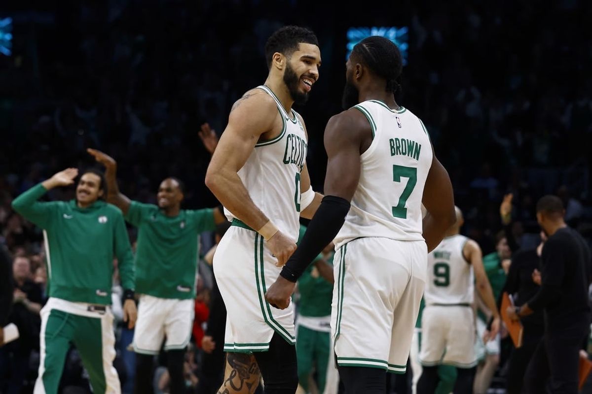 Jan 10, 2024; Boston, Massachusetts, USA; Boston Celtics forward Jayson Tatum (0) and guard Jaylen Brown (7) celebrate during overtime of their 127-120 win over the Minnesota Timberwolves  at TD Garden.