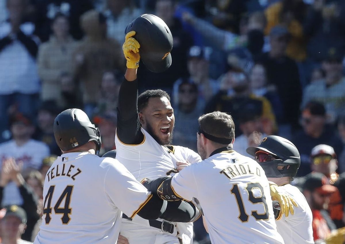 Apr 7, 2024; Pittsburgh, Pennsylvania, USA; Pittsburgh Pirates designated hitter Edward Olivares (top) celebrates with teammates after driving in the game winning runs against the Baltimore Orioles during the ninth inning at PNC Park.
