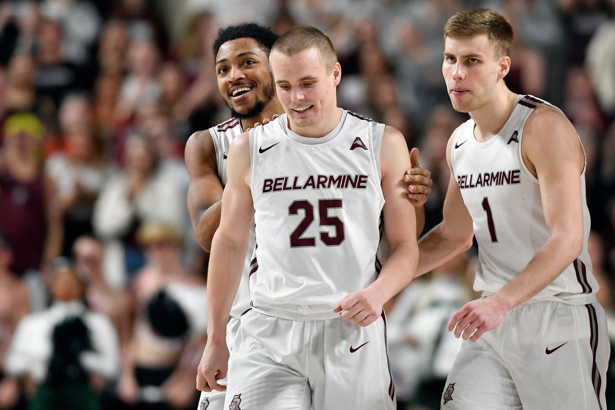 Teammates flank CJ Fleming (front) after he hits a game-winning shot against Jacksonville.
