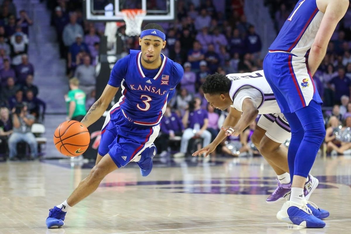Feb 5, 2024; Manhattan, Kansas, USA; Kansas Jayhawks guard Dejuan Harris Jr. (3) dribbles around a pick on Kansas State Wildcats guard Tylor Perry (2) during the second half at Bramlage Coliseum.