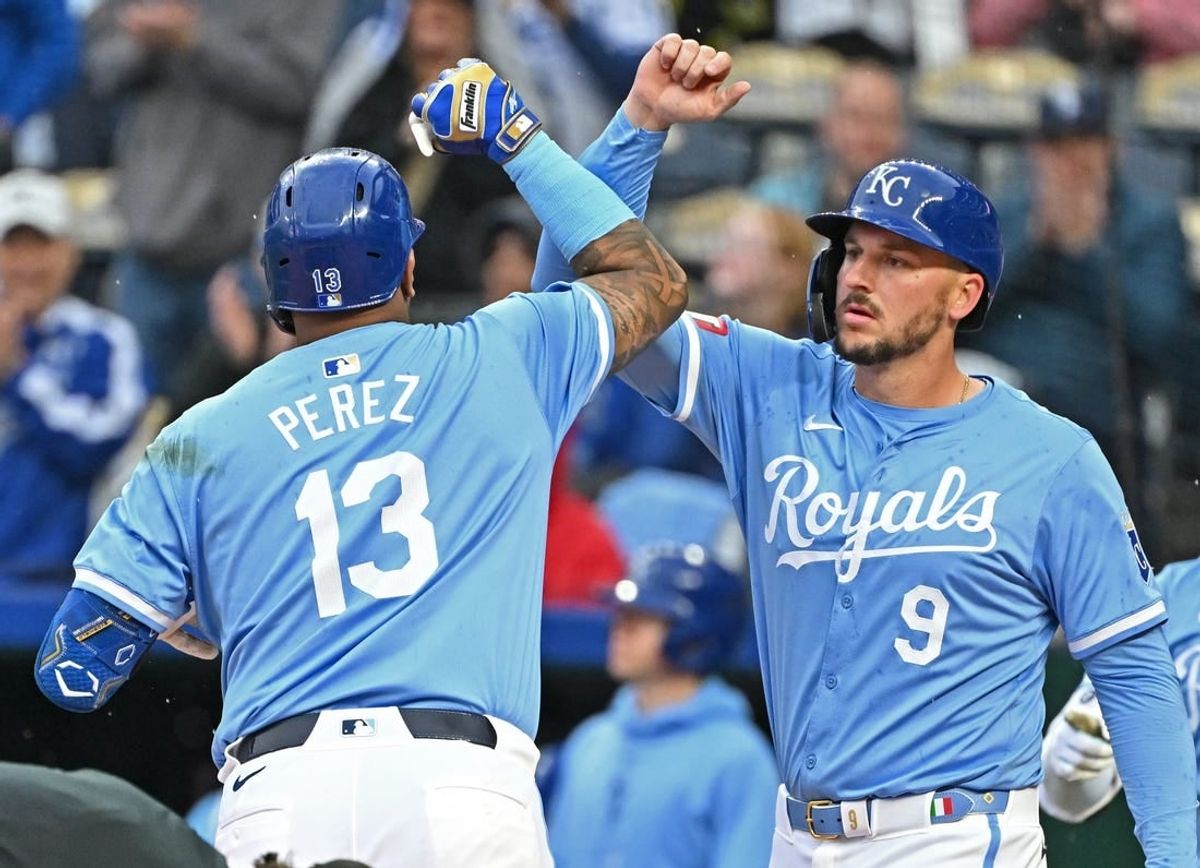 Apr 25, 2024; Kansas City, Missouri, USA;  Kansas City Royals Salvador Perez (13) celebrates with Vinnie Pasquantino (9) after hitting a two run home in the first inning against the Toronto Blue Jays at Kauffman Stadium.