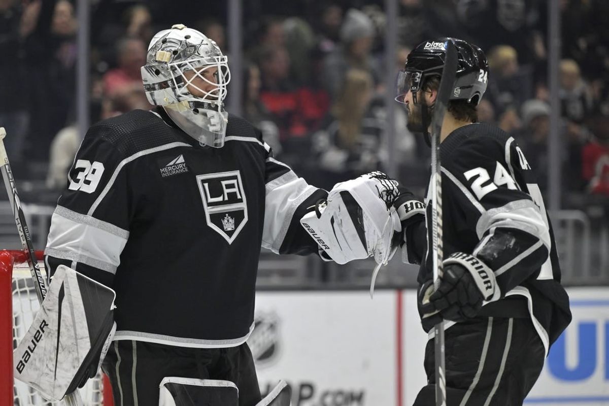 Mar 3, 2024; Los Angeles, California, USA; Los Angeles Kings center Phillip Danault (24) is congratulated by goaltender Cam Talbot (39) after scoring a hat trick in the third period against the New Jersey Devils at Crypto.com Arena.