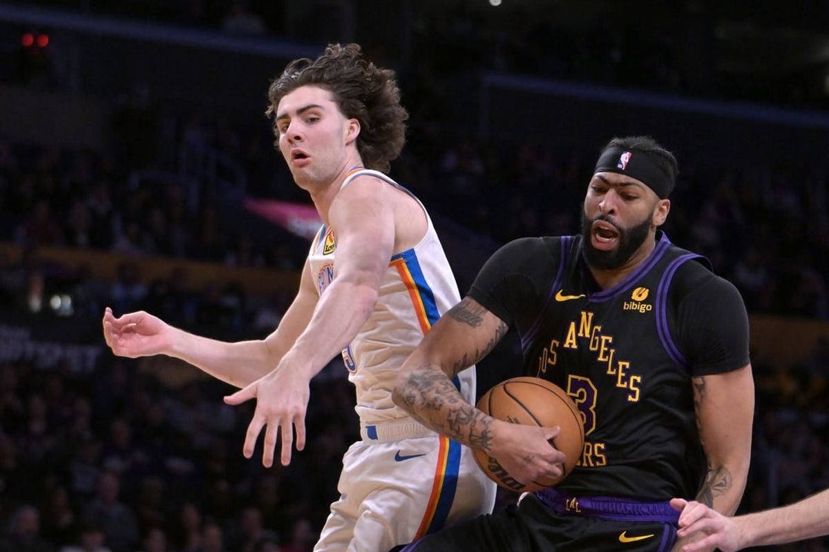Jan 15, 2024; Los Angeles, California, USA;   Oklahoma City Thunder guard Josh Giddey (3) and Los Angeles Lakers forward Anthony Davis (3) go for a rebound in the first half at Crypto.com Arena.
