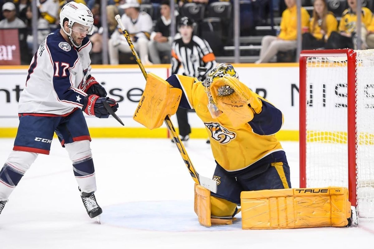 Apr 13, 2024; Nashville, Tennessee, USA; Nashville Predators goaltender Juuse Saros (74) blocks the puck against the Columbus Blue Jackets during the second period at Bridgestone Arena.