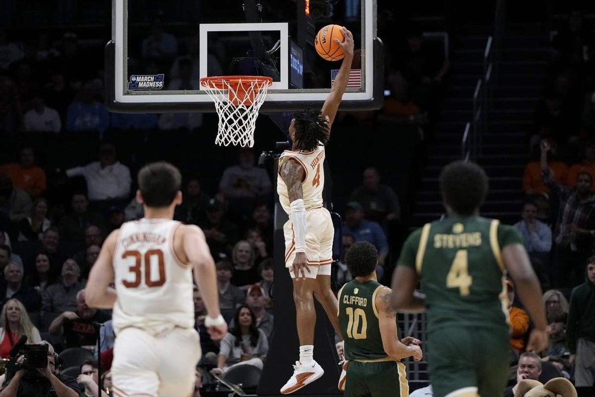 Mar 21, 2024; Charlotte, NC, USA; Texas Longhorns guard Tyrese Hunter (4) puts up a layup in the first half of the first round of the 2024 NCAA Tournament at Spectrum Center.