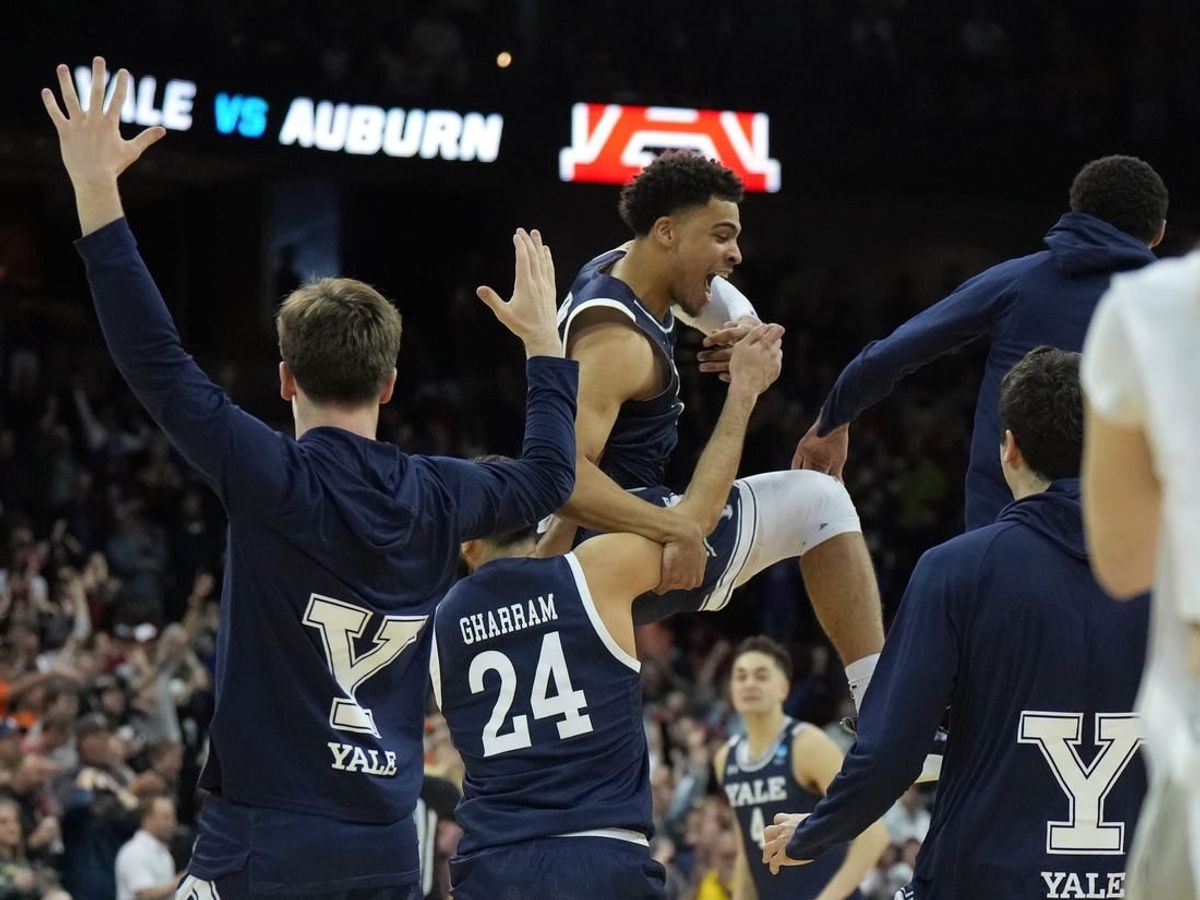 Mar 22, 2024; Spokane, WA, USA; Yale Bulldogs forward Matt Knowling (22) celebrates with guard Yassine Gharram (24) after a game against the Auburn Tigers in the first round of the 2024 NCAA Tournament at Spokane Veterans Memorial Arena.
