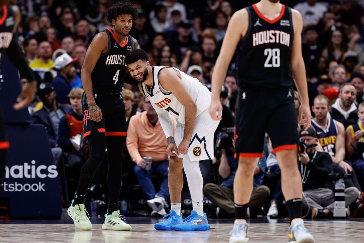 Nov 29, 2023; Denver, Colorado, USA; Denver Nuggets guard Jamal Murray (27) reacts ahead of Houston Rockets guard Jalen Green (4) after a play in the first quarter at Ball Arena.