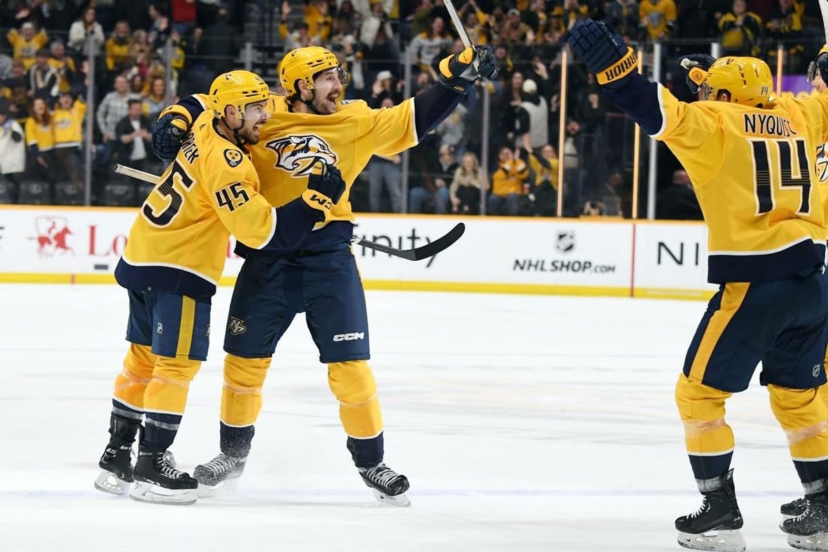Jan 13, 2024; Nashville, Tennessee, USA; Nashville Predators defenseman Alexandre Carrier (45) and left wing Filip Forsberg (9) celebrate after the game-winning goal during the third period against the New York Islanders at Bridgestone Arena.