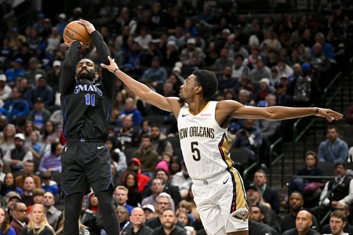 Jan 15, 2024; Dallas, Texas, USA; Dallas Mavericks guard Kyrie Irving (11) shoots the ball over New Orleans Pelicans forward Herbert Jones (5) during the second quarter at the American Airlines Center.