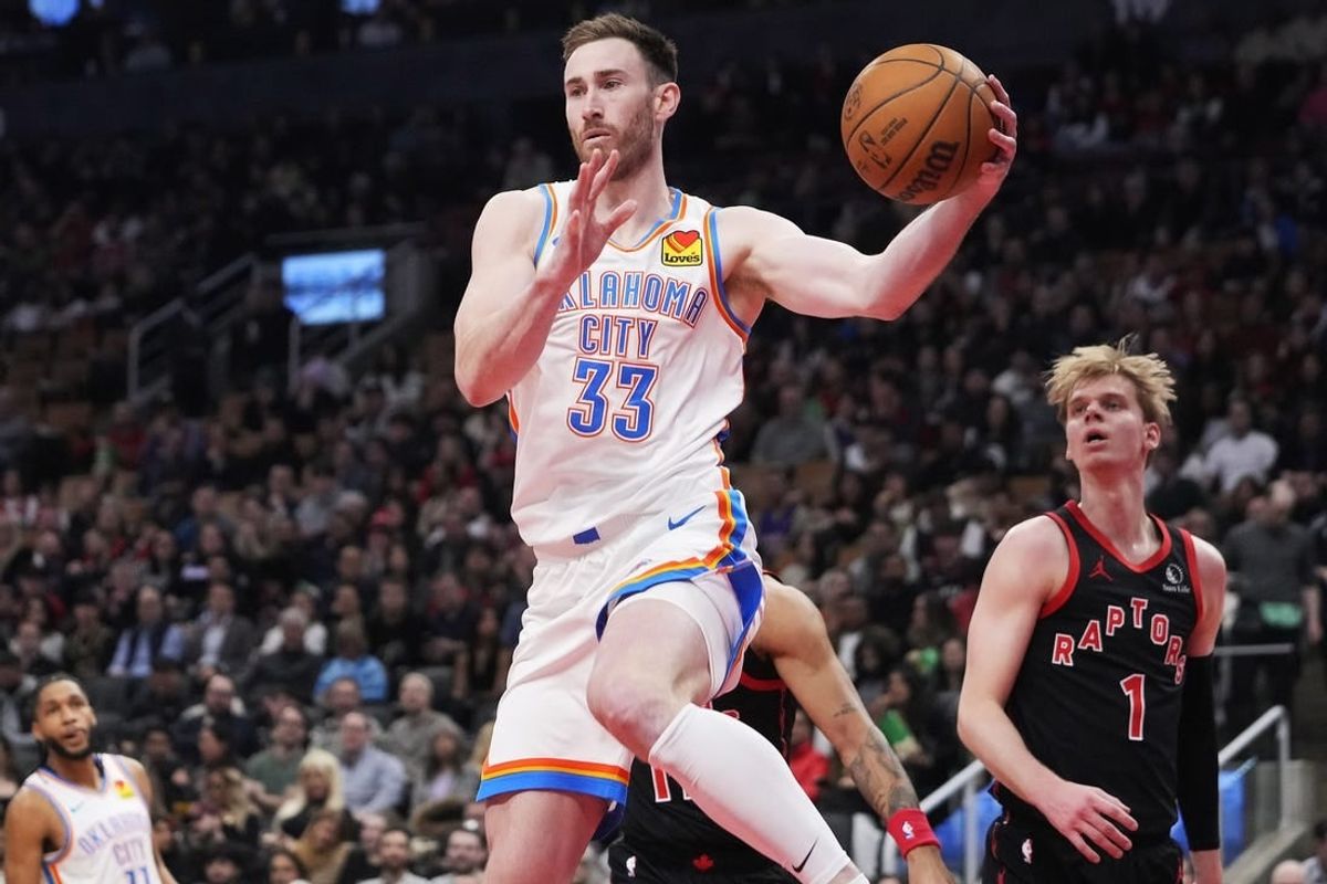Mar 22, 2024; Toronto, Ontario, CAN; Oklahoma City Thunder forward Gordon Hayward (33) goes to pass the ball as Toronto Raptors guard Gradey Dick (1) looks on during the first half at Scotiabank Arena.