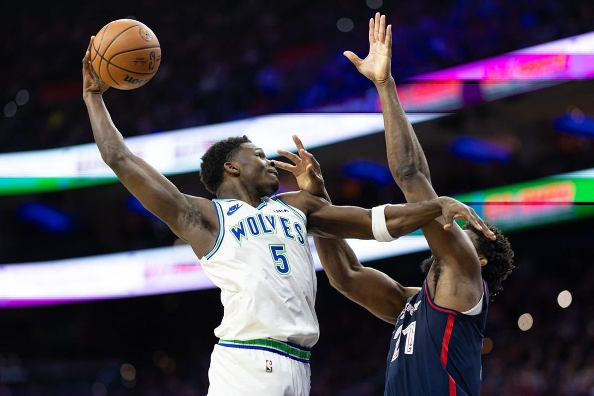 Dec 20, 2023; Philadelphia, Pennsylvania, USA; Minnesota Timberwolves guard Anthony Edwards (5) drives for a shot against Philadelphia 76ers center Joel Embiid (21) during the second quarter at Wells Fargo Center.