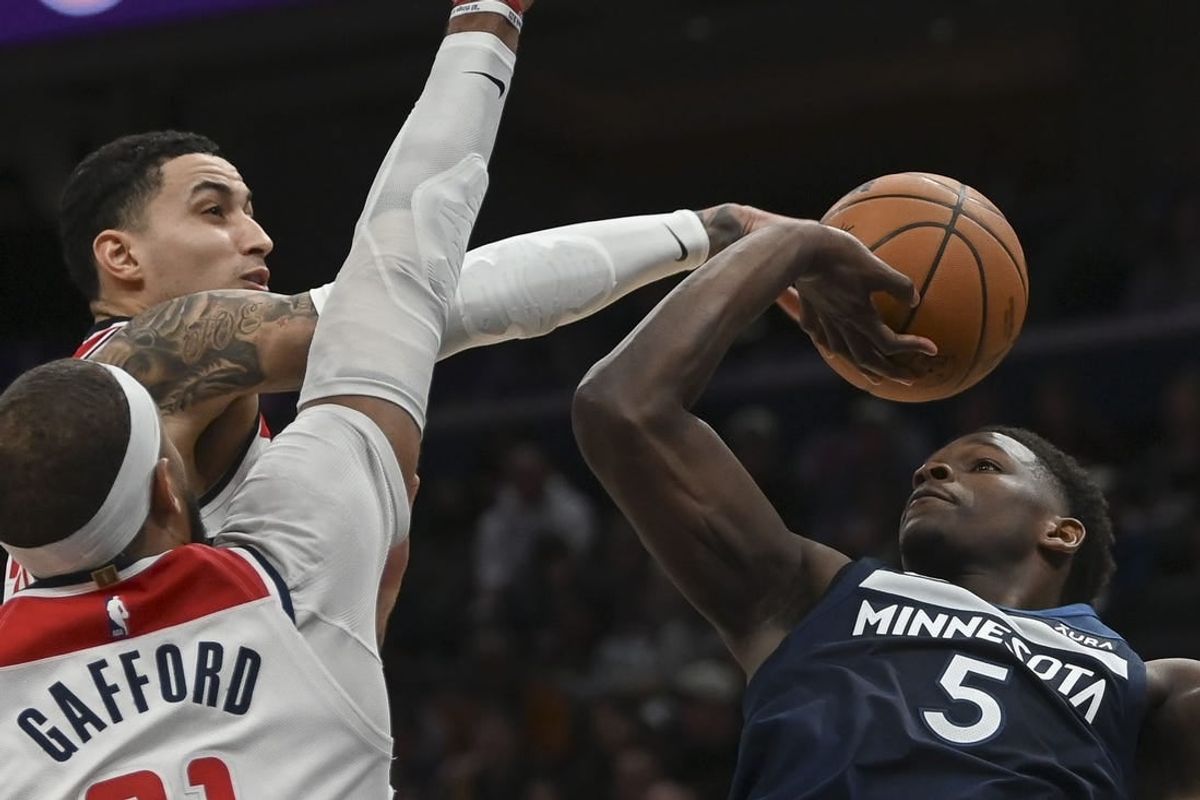 Jan 24, 2024; Washington, District of Columbia, USA;  Washington Wizards forward Kyle Kuzma (33) blocks Minnesota Timberwolves guard Anthony Edwards (5) first half shot at Capital One Arena.