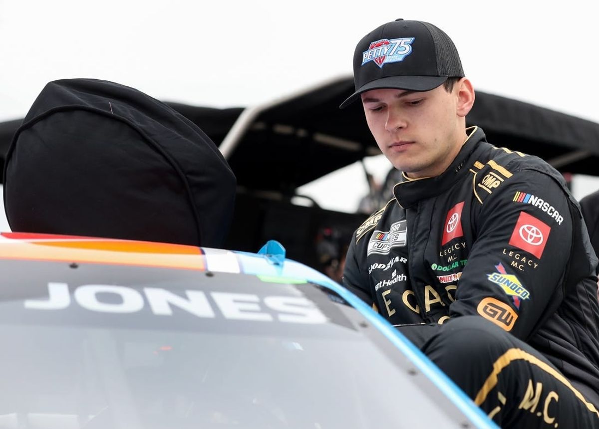 Apr 27, 2024; Dover, Delaware, USA; NASCAR Cup Series driver Corey Heim climbs into his car during practice and qualifying for the Wurth 400 at Dover Motor Speedway.