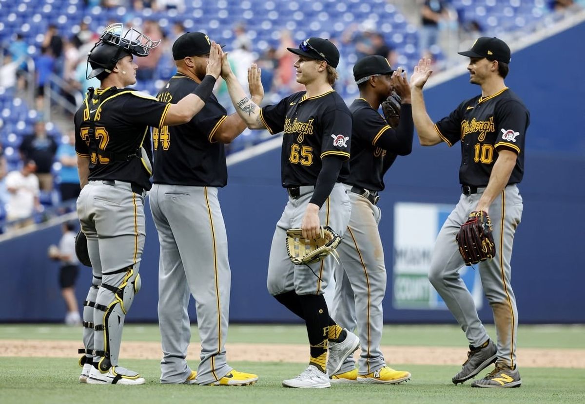 Mar 30, 2024; Miami, Florida, USA; The Pittsburgh Pirates celebrate after defeating the Miami Marlins following the game at loanDepot Park.