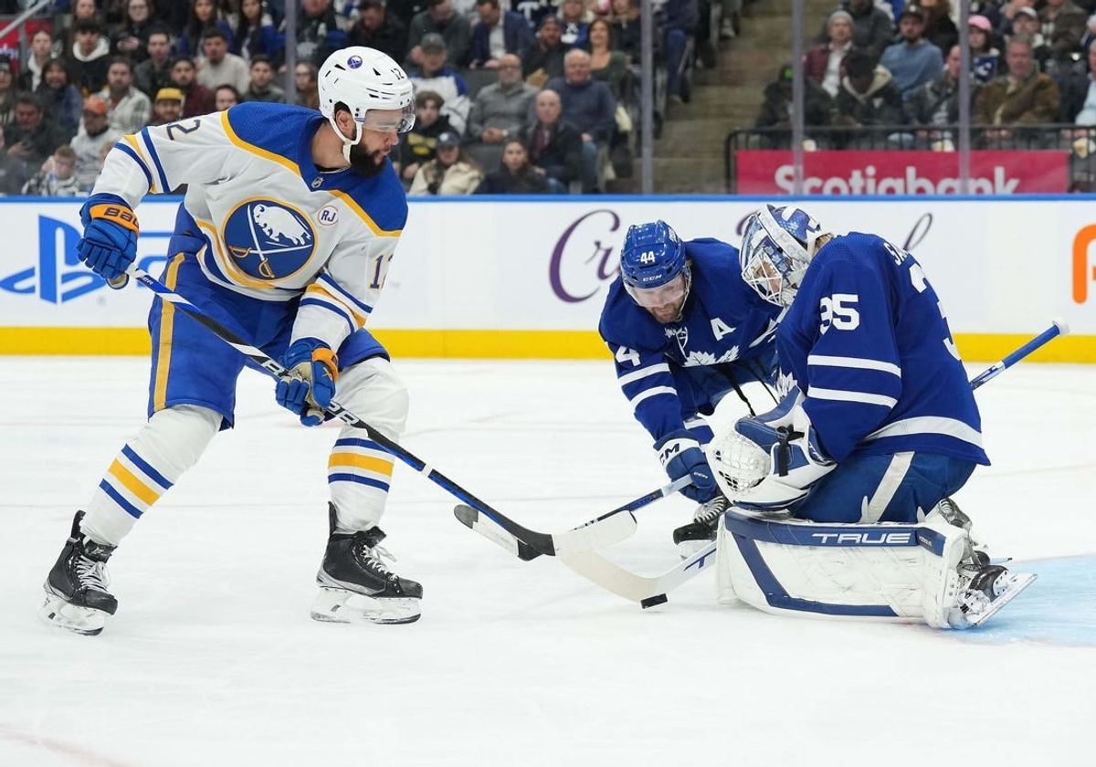 Mar 6, 2024; Toronto, Ontario, CAN; Toronto Maple Leafs defenseman Morgan Rielly (44) battles for the puck with Buffalo Sabres left wing Jordan Greenway (12) in front of goaltender Ilya Samsonov (35) during the second period at Scotiabank Arena.