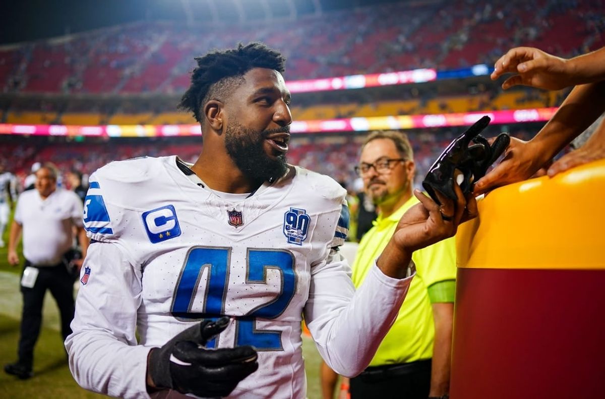 Sep 7, 2023; Kansas City, Missouri, USA; Detroit Lions linebacker Jalen Reeves-Maybin (42) gives a glove to a fan after defeating the Kansas City Chiefs at GEHA Field at Arrowhead Stadium.