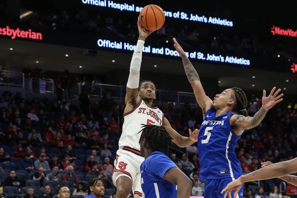 Dec 30, 2023; Elmont, New York, USA;  St. John's Red Storm guard Daniss Jenkins (5) shoots past Hofstra Pride guard Jaquan Carlos (5) in the second half at UBS Arena.