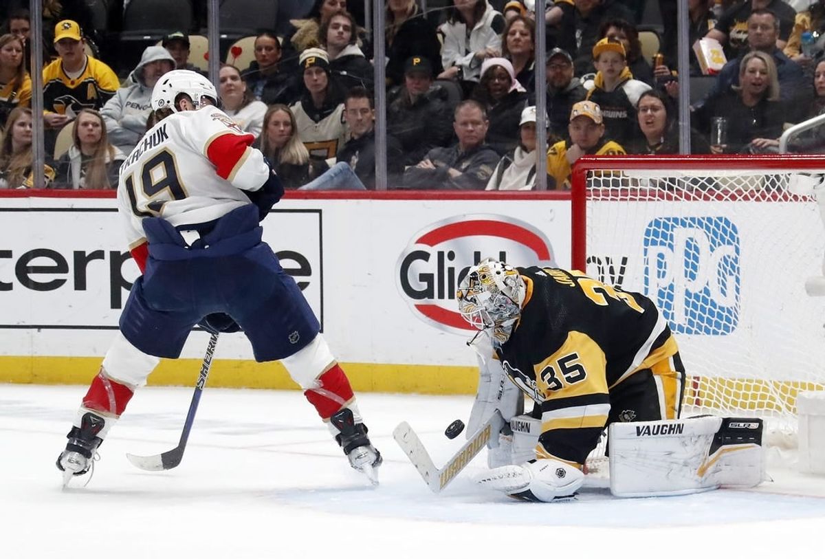 Feb 14, 2024; Pittsburgh, Pennsylvania, USA; Pittsburgh Penguins goaltender Tristan Jarry (35) makes a save against Florida Panthers left wing Matthew Tkachuk (19) during the second period at PPG Paints Arena.