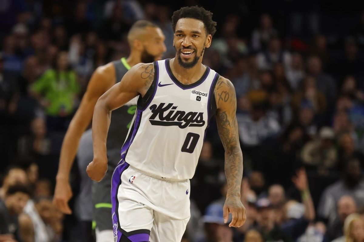 Mar 1, 2024; Minneapolis, Minnesota, USA; Sacramento Kings guard Malik Monk (0) celebrates his three-point basket against the Minnesota Timberwolves in overtime at Target Center.