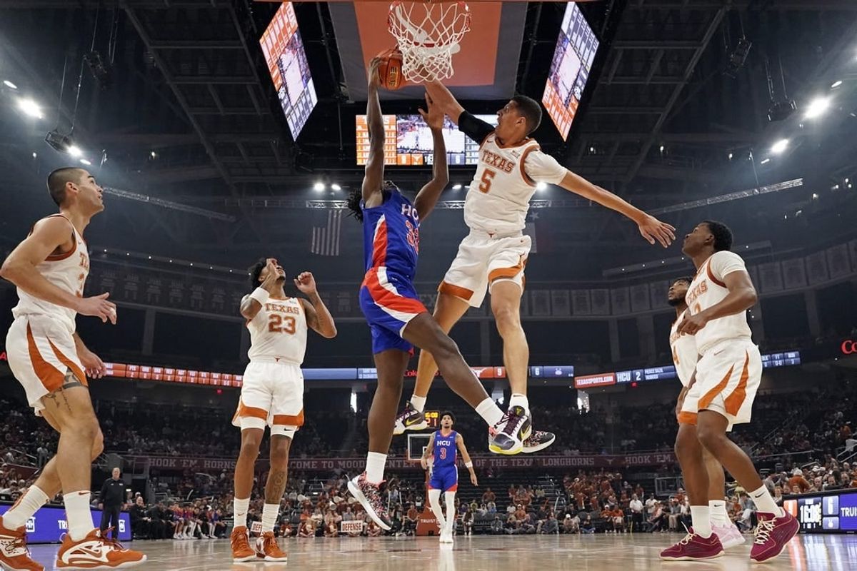 Dec 9, 2023; Austin, Texas, USA; Texas Longhorns forward Kadin Shedrick (5) blocks the shot attempted by Houston Christian Huskies forward Michael Imariagbe (33) during the first half at Moody Center.