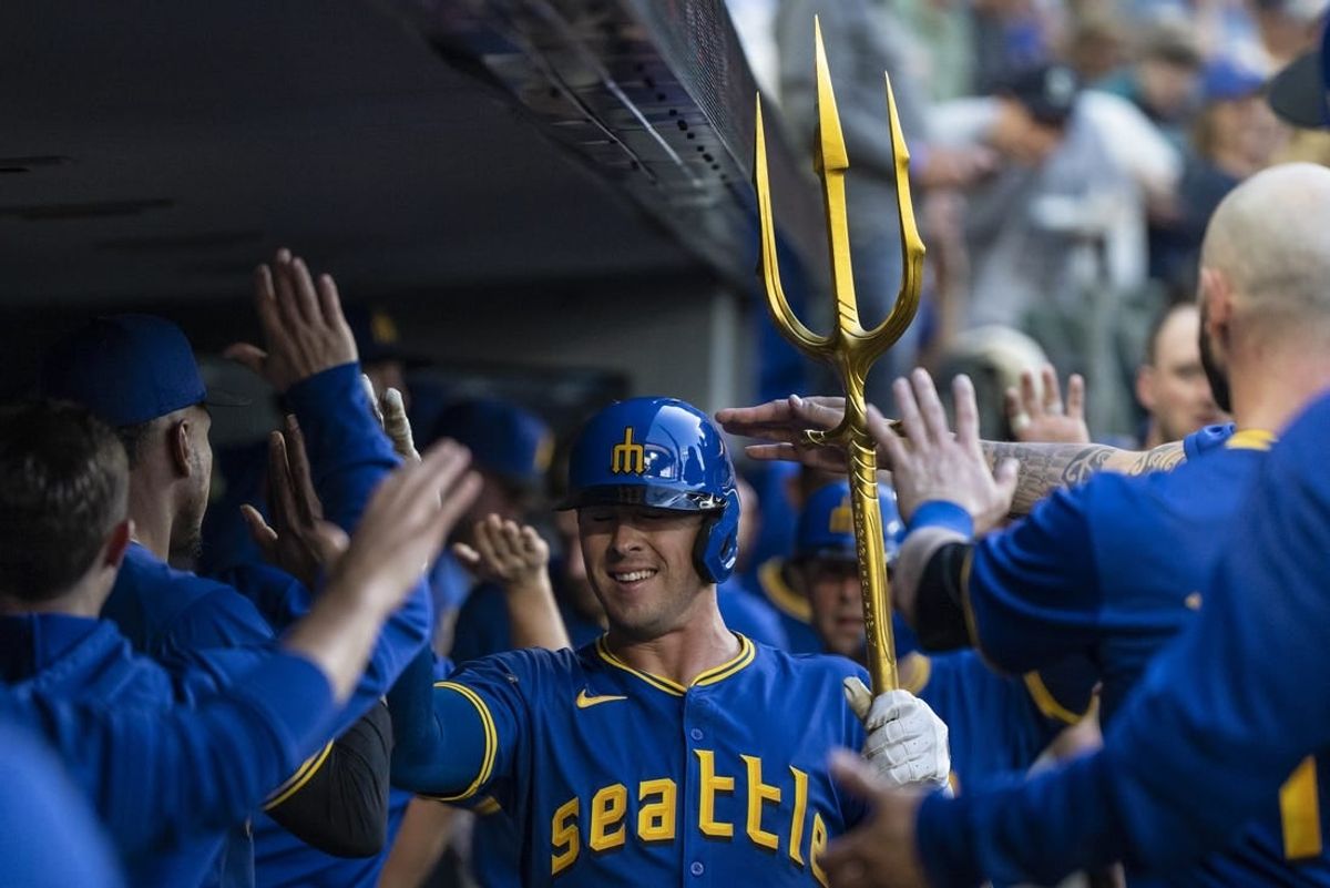 May 10, 2024; Seattle, Washington, USA; Seattle Mariners shortstop Dylan Moore (25) celebrates in the dugout with teammates after hitting a two-run home run during the fourth inning against the Oakland Athletics at T-Mobile Park.