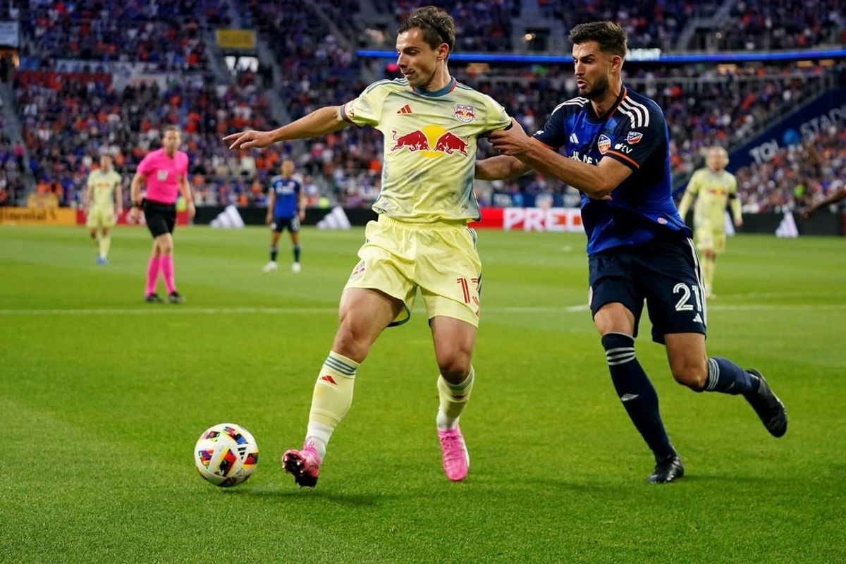 New York Red Bulls forward Dante Vanzeir (13) plays a pass back as FC Cincinnati defender Matt Miazga (21) defends in the first half of an MLS soccer game, Saturday, April 6, 2024, at TQL Stadium in Cincinnati.