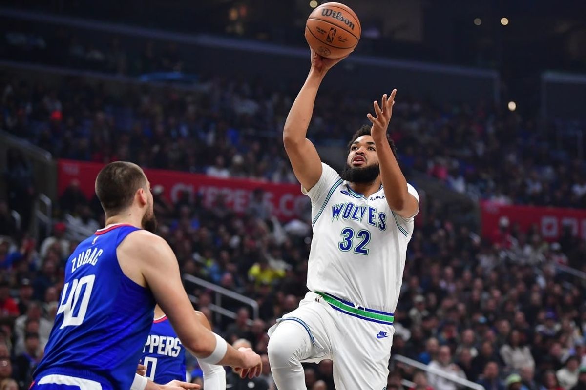 Feb 12, 2024; Los Angeles, California, USA; Minnesota Timberwolves center Karl-Anthony Towns (32) shoots against Los Angeles Clippers center Ivica Zubac (40) during the first half at Crypto.com Arena.