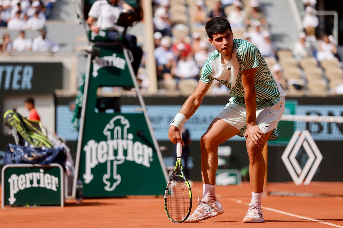 Carlos Alcaraz reacts with pain at the end of the third game of  the third set during his semifinal match of the French Open against Novak Djokovic