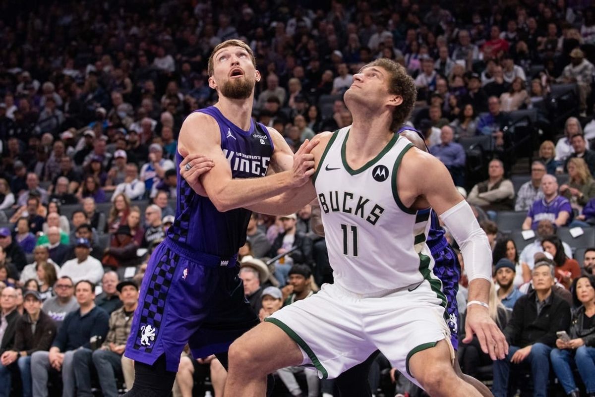 Mar 12, 2024; Sacramento, California, USA; Sacramento Kings forward Domantas Sabonis (10) and Milwaukee Bucks center Brook Lopez (11) fight for position under the basket during the second quarter at Golden 1 Center.