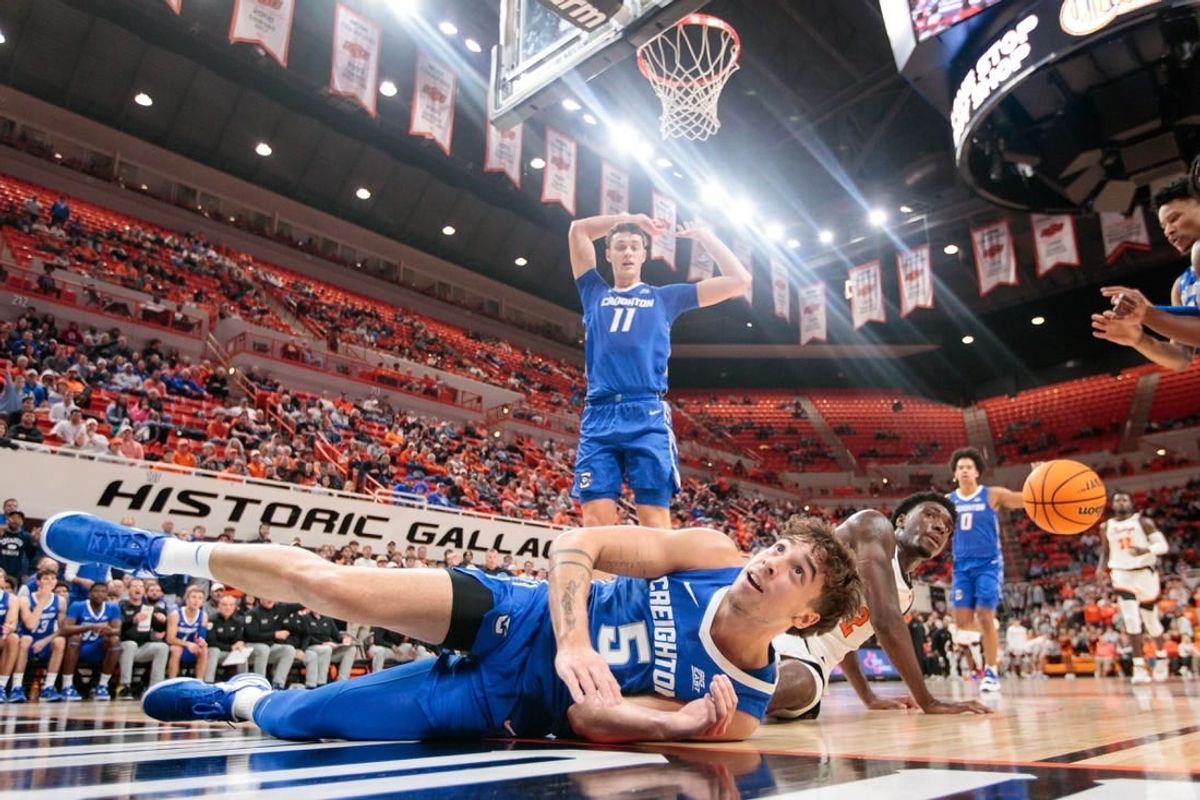 Nov 30, 2023; Stillwater, Oklahoma, USA; Oklahoma State Cowboys forward Eric Dailey Jr. (2) and Creighton Bluejays guard Francisco Farabello (5) dive after a loose ball during the first half at Gallagher-Iba Arena.