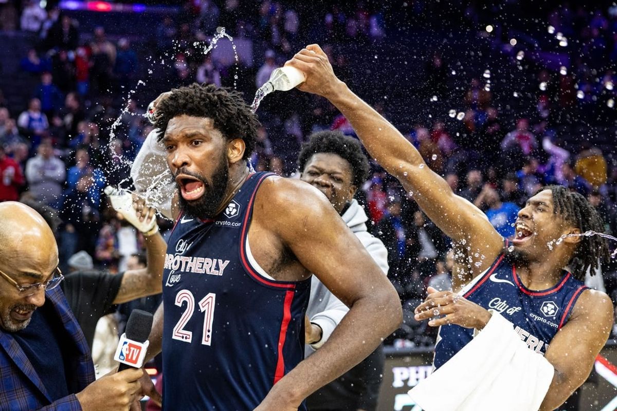 Jan 22, 2024; Philadelphia, Pennsylvania, USA; Philadelphia 76ers center Joel Embiid (21) is doused with water by teammates after scoring 70 points in a victory against the San Antonio Spurs at Wells Fargo Center.