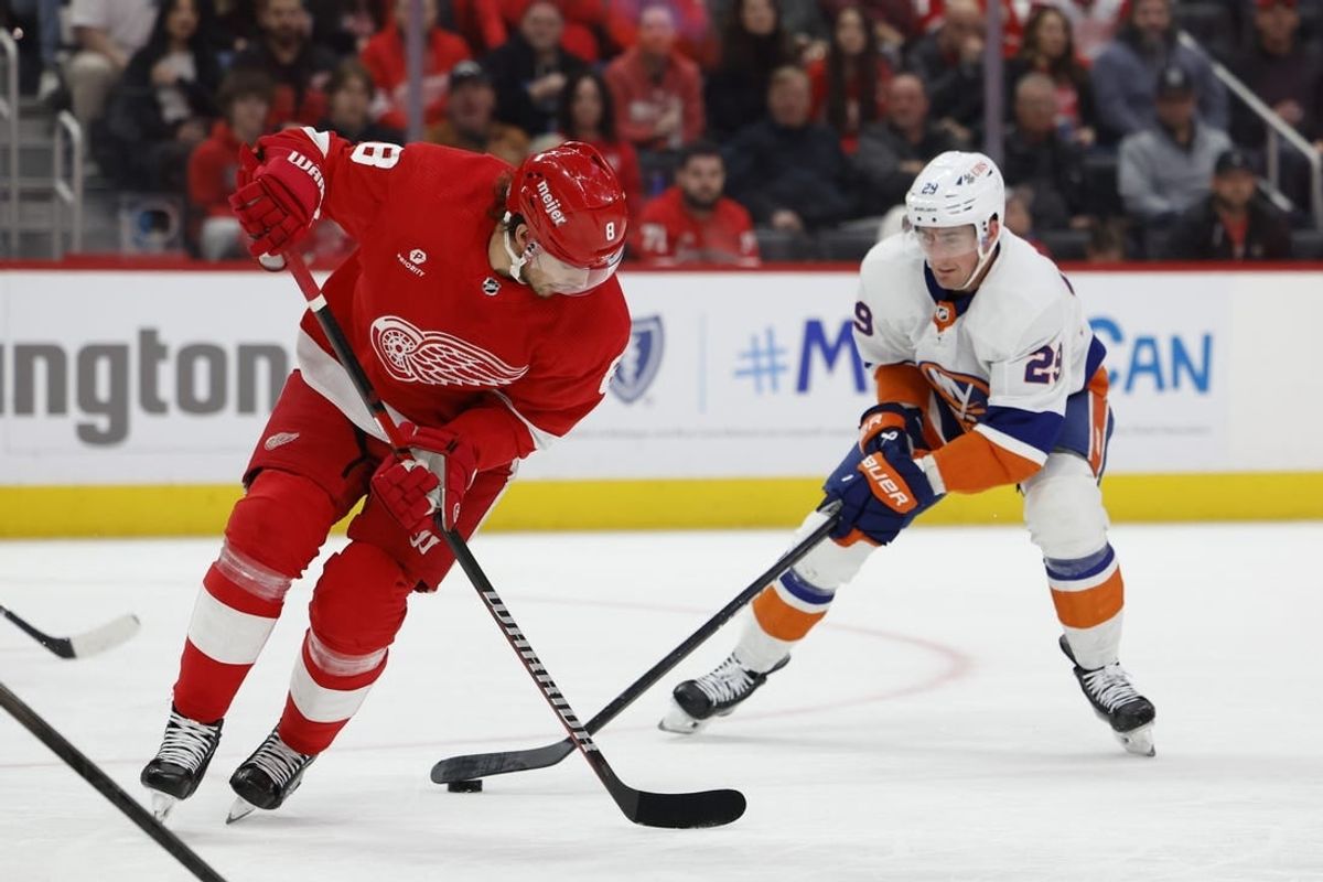 Feb 29, 2024; Detroit, Michigan, USA;  New York Islanders center Brock Nelson (29) skates with the puck defended by Detroit Red Wings defenseman Ben Chiarot (8) in the first period at Little Caesars Arena.