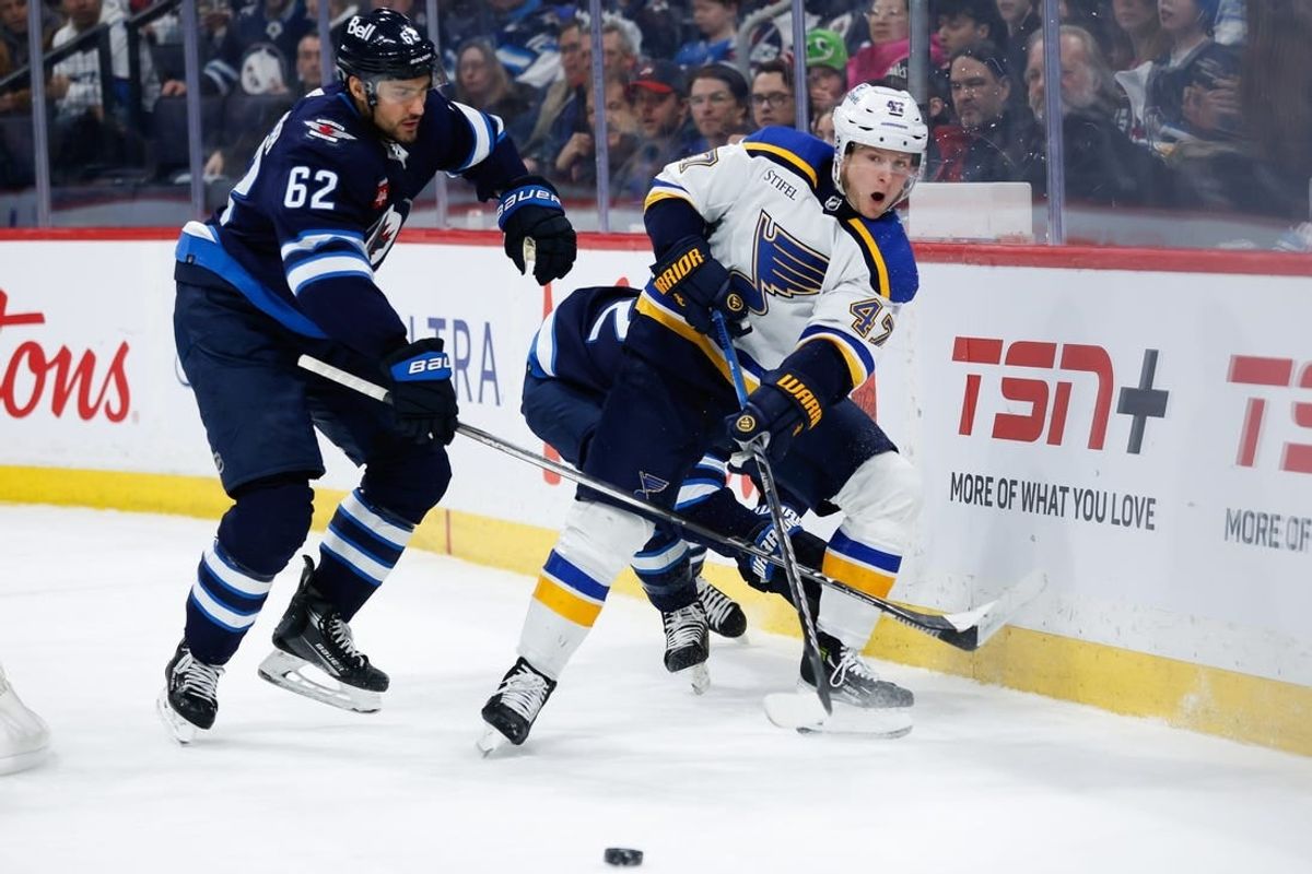 Feb 27, 2024; Winnipeg, Manitoba, CAN; St. Louis Blues defenseman Torey Krug (47) makes a pass against Winnipeg Jets forward Nino Niederreiter (62) during the second period at Canada Life Centre.
