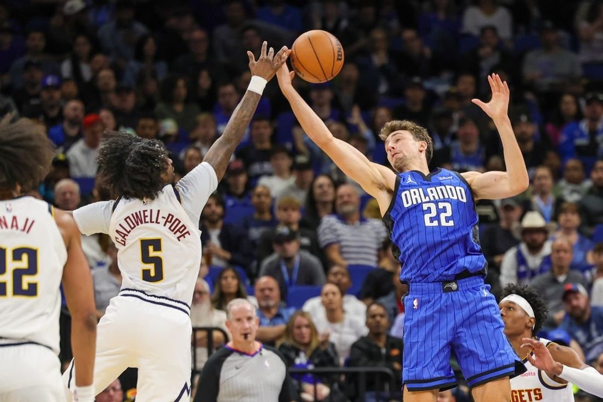 Nov 22, 2023; Orlando, Florida, USA; Orlando Magic forward Franz Wagner (22) and Denver Nuggets guard Kentavious Caldwell-Pope (5) battle for the ball during the second quarter at Amway Center.