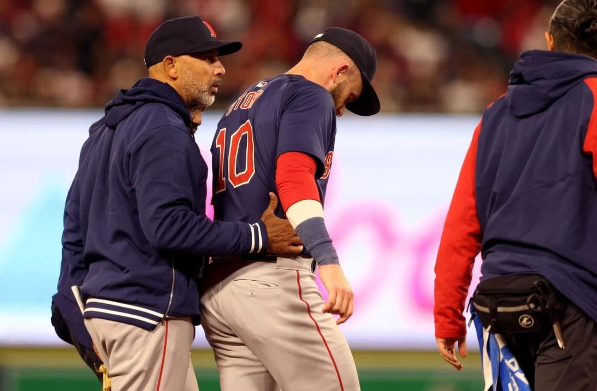 Apr 5, 2024; Anaheim, California, USA; Boston Red Sox manager Alex Cora (13) talks to shortstop Trevor Story (10) after an injury during the fourth inning against the Los Angeles Angels at Angel Stadium.