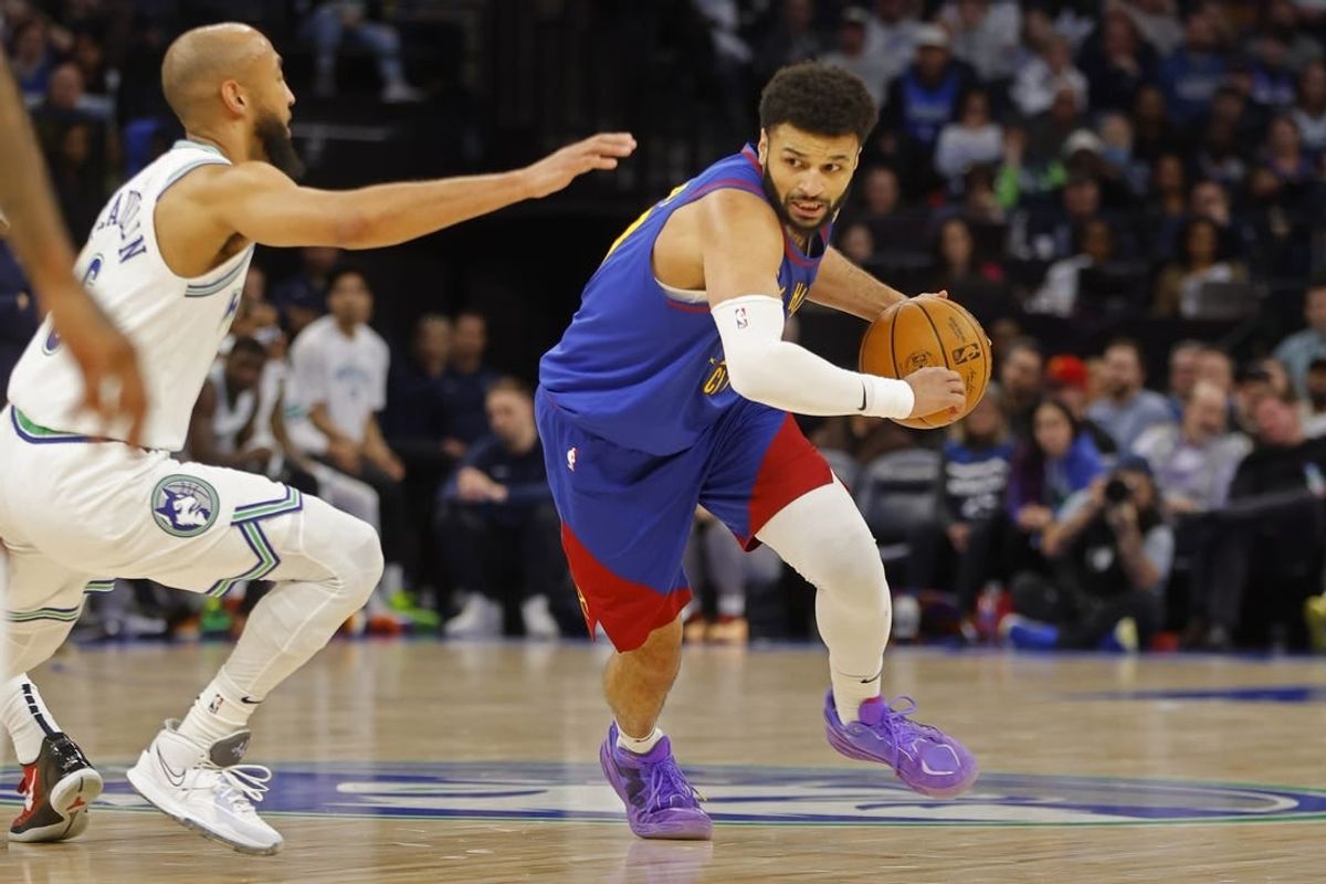 Mar 19, 2024; Minneapolis, Minnesota, USA; Denver Nuggets guard Jamal Murray (27) works around Minnesota Timberwolves guard Jordan McLaughlin (6) in the second quarter at Target Center.