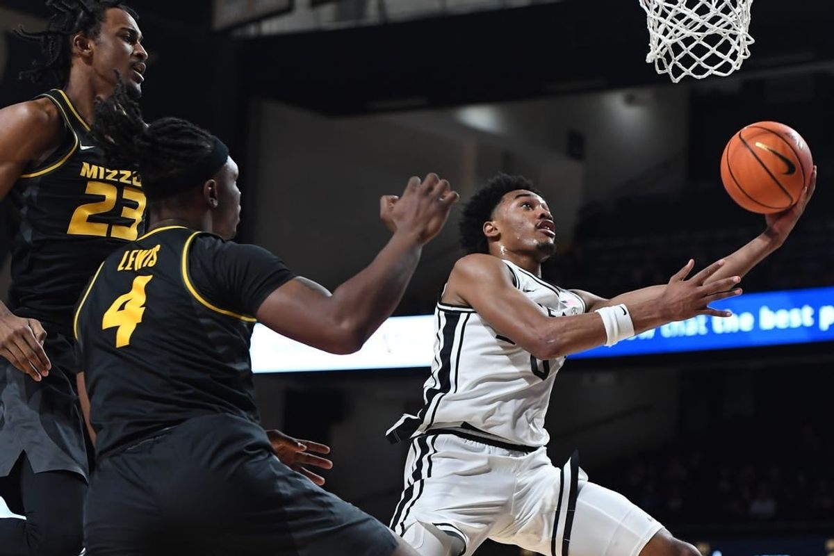 Feb 3, 2024; Nashville, Tennessee, USA; Vanderbilt Commodores guard Tyrin Lawrence (0) scores past Missouri Tigers forward Aidan Shaw (23) and guard Curt Lewis (4) during the first half at Memorial Gymnasium.
