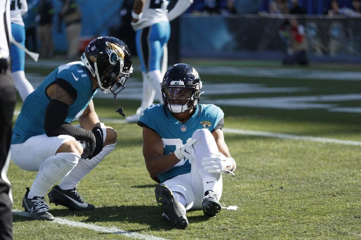 Dec 31, 2023; Jacksonville, Florida, USA; Jacksonville Jaguars wide receiver Jamal Agnew (39) holds his leg after an injury with teammate wide receiver Parker Washington (11) checking in against the Carolina Panthers during the second quarter at EverBank Stadium.