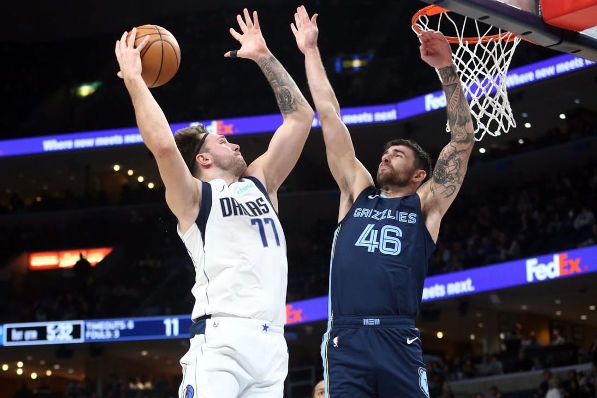 Dec 11, 2023; Memphis, Tennessee, USA; Dallas Mavericks guard Luka Doncic (77) drives to the basket as Memphis Grizzlies guard John Konchar (46) defends during the first half at FedExForum.