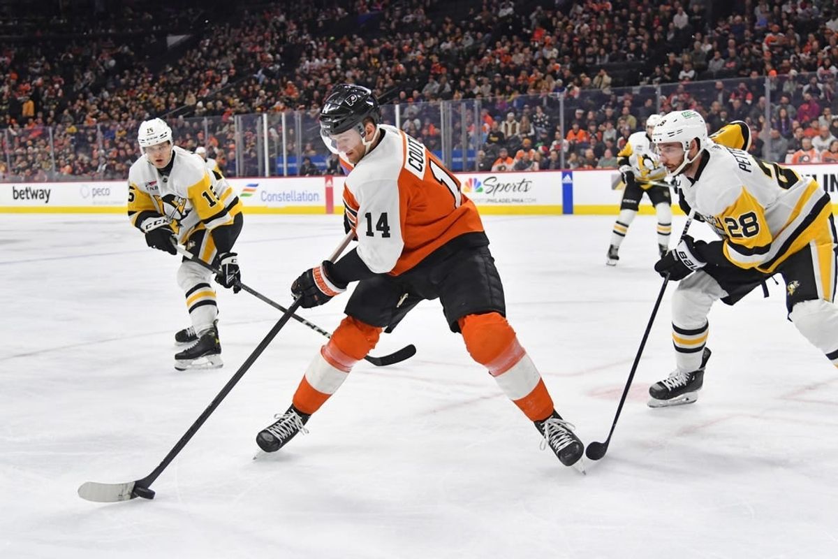 Dec 4, 2023; Philadelphia, Pennsylvania, USA; Philadelphia Flyers center Sean Couturier (14) controls the puck against Pittsburgh Penguins left wing Joona Koppanen (15) and defenseman Marcus Pettersson (28) during the first period at Wells Fargo Center.