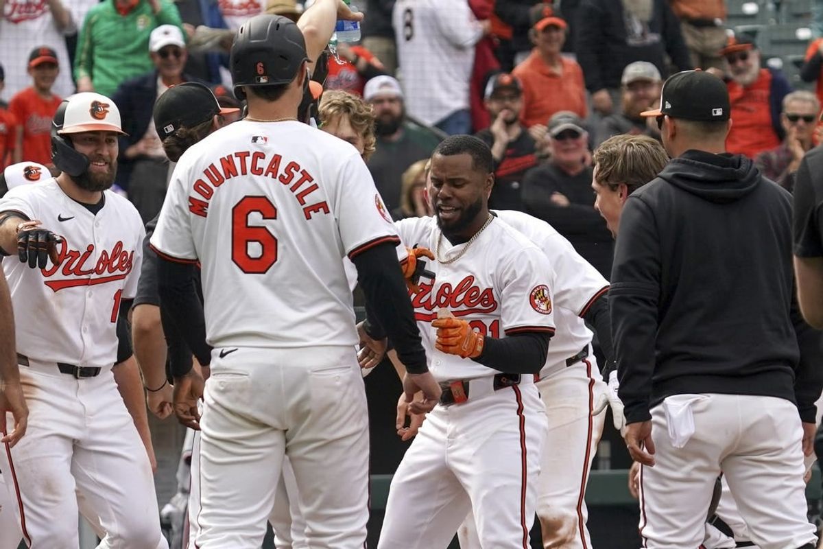 Apr 17, 2024; Baltimore, Maryland, USA; Baltimore Orioles outfielder Cedric Mullins (center) greeted by teammates following his game winning two run home run in the ninth inning against the Minnesota Twins at Oriole Park at Camden Yards.