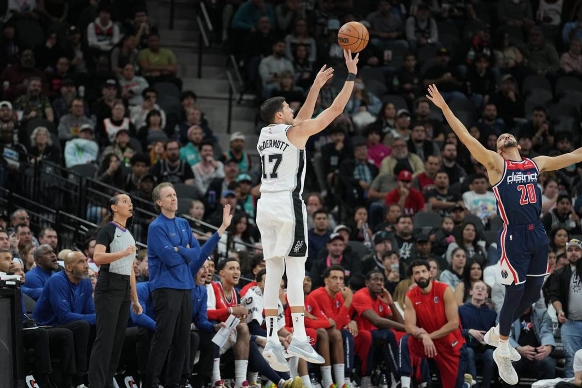 Jan 29, 2024; San Antonio, Texas, USA;  San Antonio Spurs forward Doug McDermott (17) shoots over Washington Wizards guard Landry Shamet (20) in the second half at Frost Bank Center.