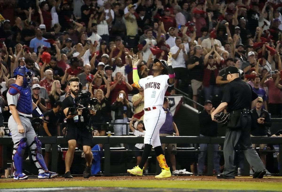 Oct 11, 2023; Phoenix, AZ, USA; Arizona Diamondbacks Geraldo Perdomo (2) reacts after hitting a home run off Los Angeles Dodgers starting pitcher Lance Lynn (35) in the third inning during Game 3 of the NLDS at Chase Field.
