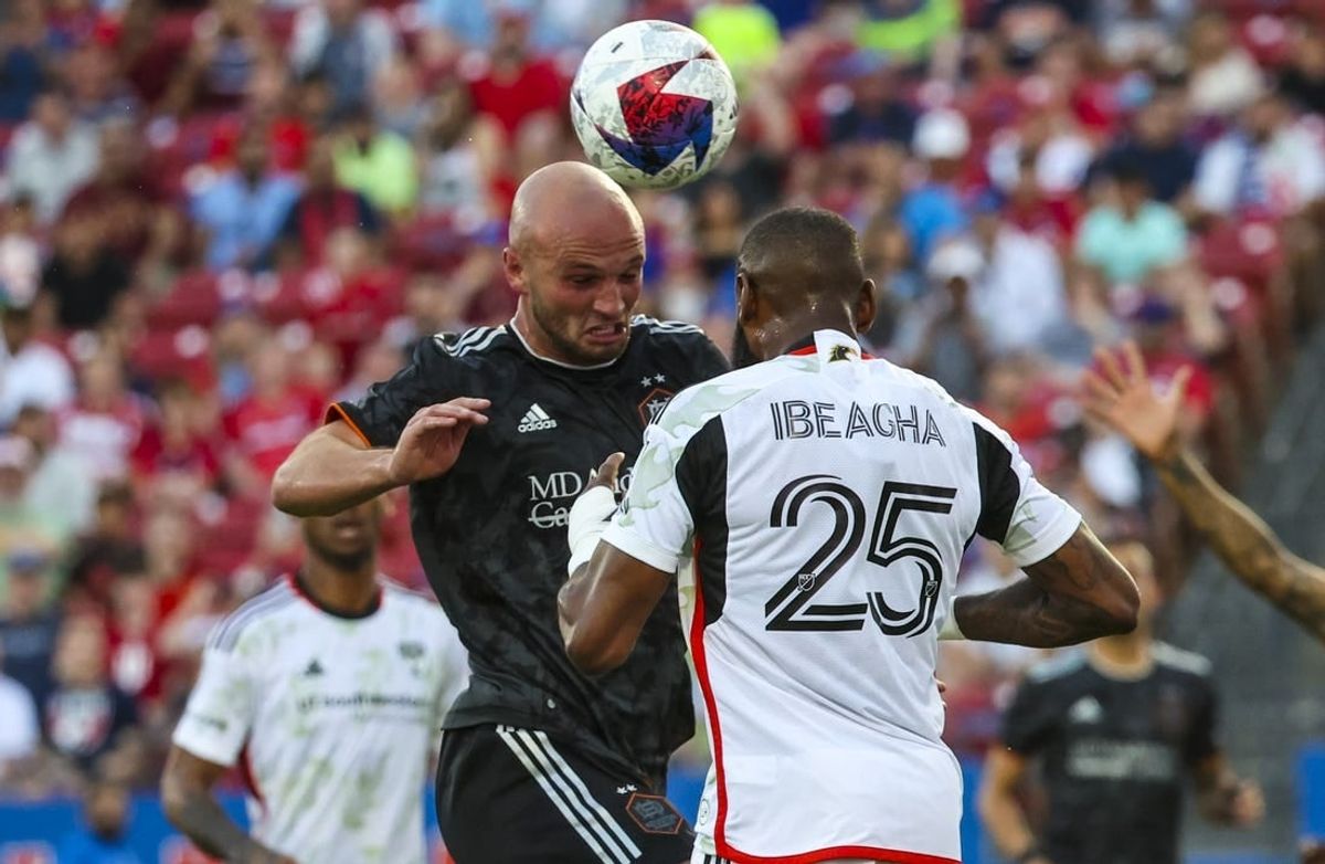May 20, 2023; Frisco, Texas, USA; Houston Dynamo defender Chase Gasper (30) heads the ball in front of FC Dallas defender Sebastien Ibeagha (25) during the first half at Toyota Stadium.